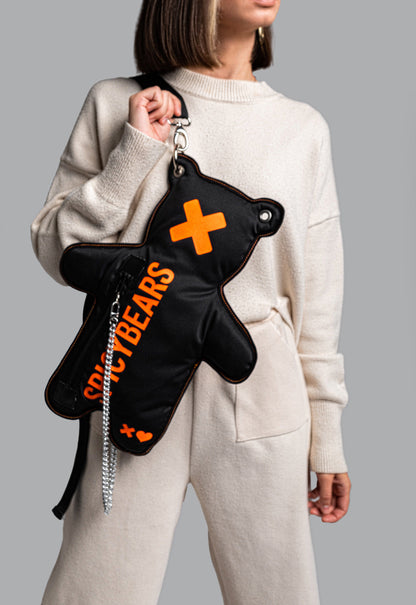 Statement accessory: Black crossbody bag with eye-catching neon orange accents