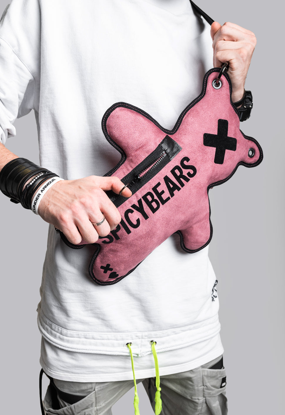 A unique dusty rose faux suede crossbody purse in the shape of an adorable bear, perfect for streetwear enthusiasts