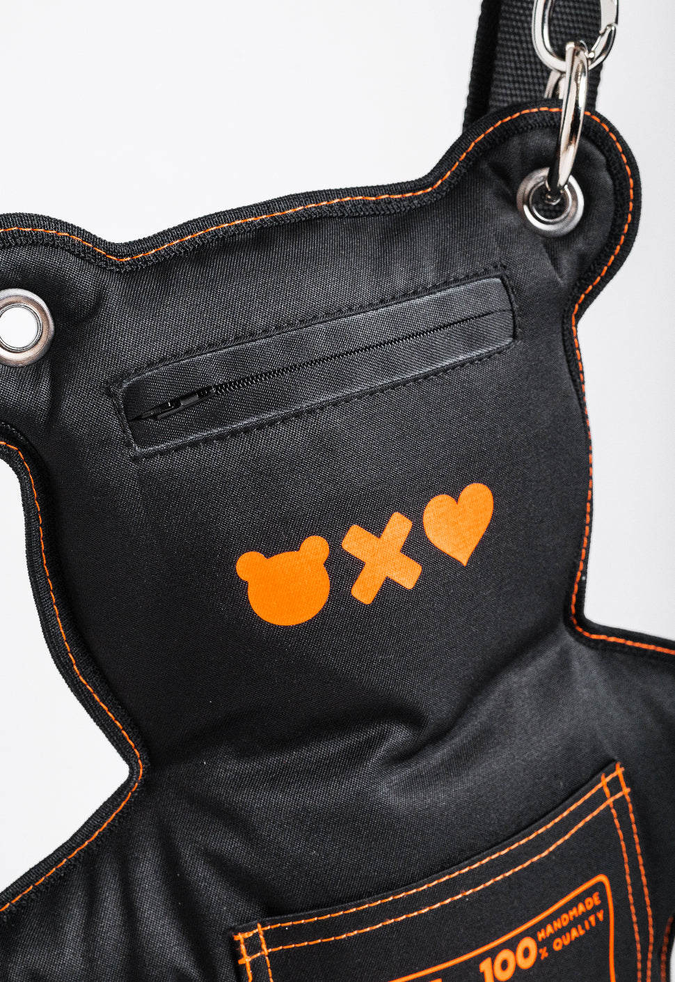 Elevate your look: Black SPICYBEARS Bag with bold neon orange print and adjustable strap